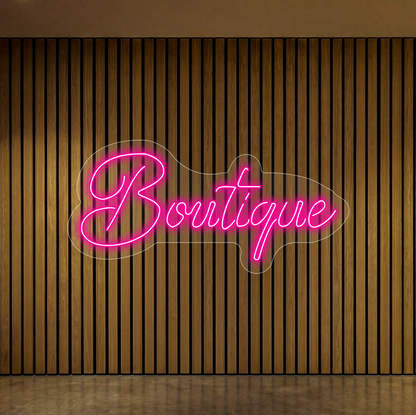 Neon z napisem "Boutique" na tle lameli